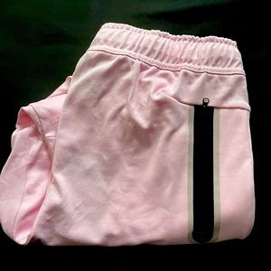 I am selling pink nike tech pants size small.
